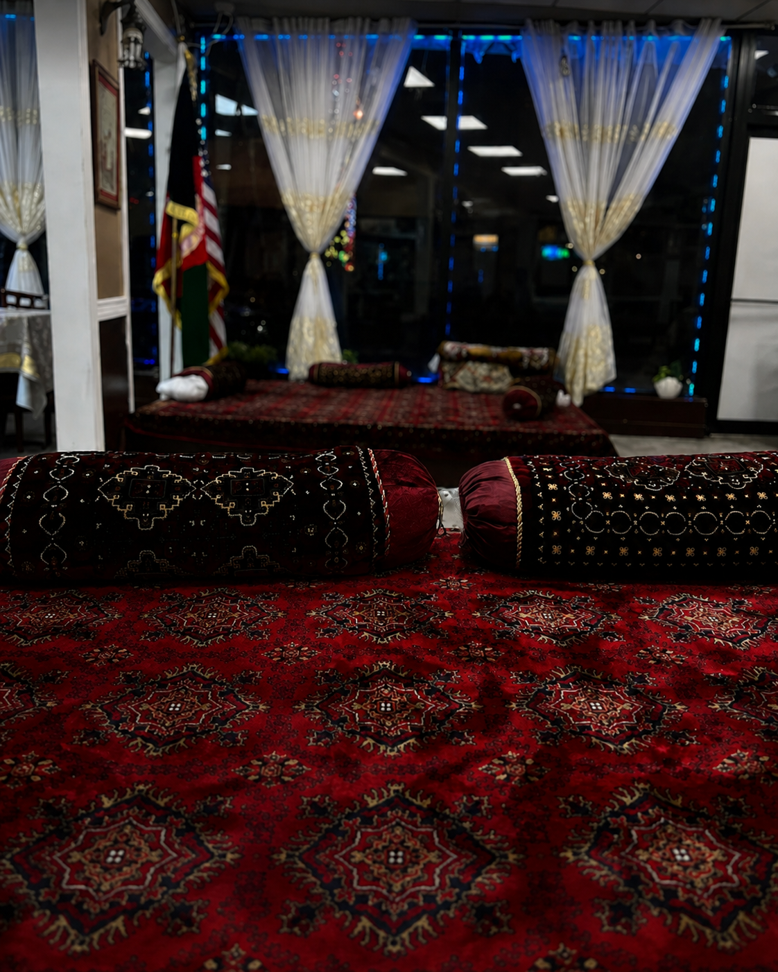 Traditional Afghan floor seating with carpets and cushions at Afghan House